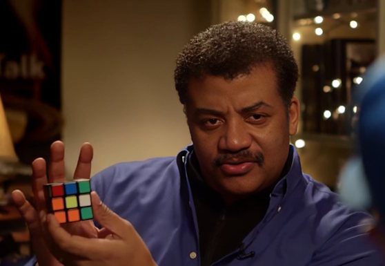 Neil deGrasse Tyson holding a rubik's cube